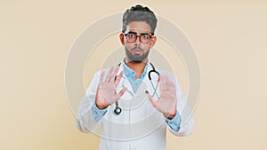 Confused upset Indian doctor man pointing fingers herself, rejection, refusal problem, stop sign