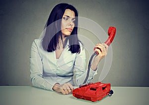 Confused woman receiving bad news over the telephone