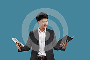 Confused young business man reading document