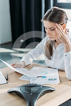 confused young businesswoman doing paperwork