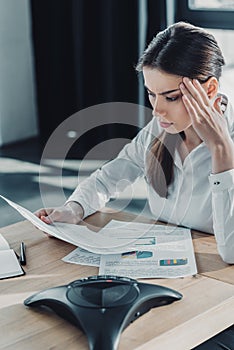 confused young businesswoman doing paperwork