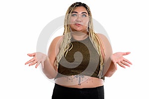 Confused young fat Asian woman looking up while shrugging should