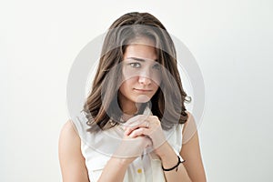 Confused young female posing isolated at white wall.