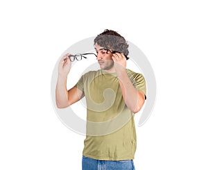 Confused young man fixing glasses, trying to look through lenses, poor sight farsightedness, myopia. Male eyes problem, suffering photo