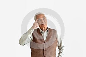 Confusing and forgetful elderly asian man with thinking gesture, Alzheimer`s disease.