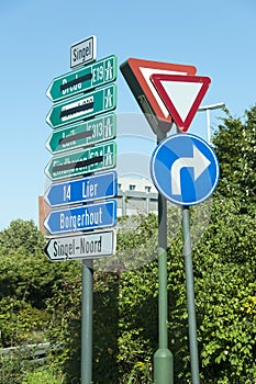 Confusing road direction signs in dutch informing drivers on street crossing