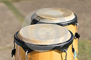 Conga drum set on grass in a stadium for cheer.