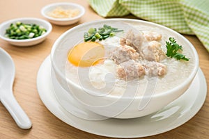 Congee with minced pork and boiled egg in bowl