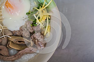 Congee with minced pork, liver, pork entrails and boiled egg in a bowl photo