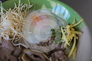 Congee with minced pork, liver, pork entrails and soft boiled in a bowl photo