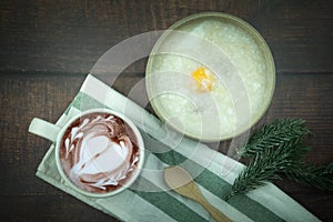 Congee or rice porridge minced pork and egg served with cup of hot chocolate