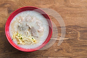 Congee, Rice porridge, Rice gruel, Rice soup on wooden background, Top view