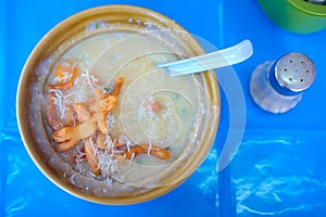 Congee rice porridge in yellow bowl