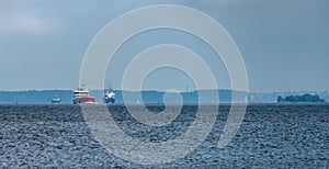 Congested traffic in the strait of Trangsund fairway from Vyborg port to Gulf of Finland with Vyborg castle and cityscape on