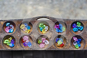 Congkak or congklak which is a mancala game of Malay origin played in Malaysia, Philippines, Singapore, Indonesia, Brunei and