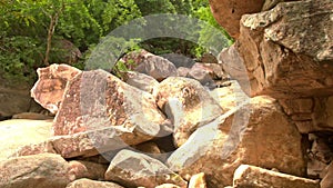 Conglomeration of Large Brown Boulders by River in Park