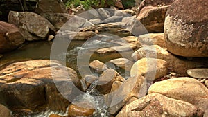 Conglomeration of Large Brown Boulders by River in Park