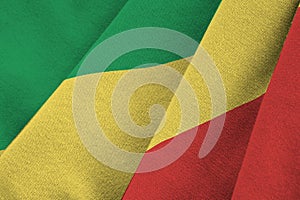 Congo flag with big folds waving close up under the studio light indoors. The official symbols and colors in banner