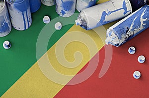 Congo flag and few used aerosol spray cans for graffiti painting. Street art culture concept