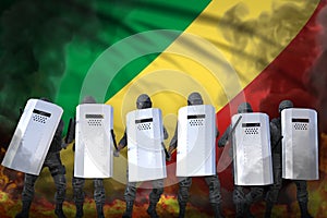 Congo police special forces in heavy smoke and fire protecting law against revolt - protest fighting concept, military 3D