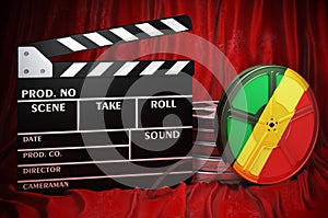 Congolese cinematography, film industry, cinema in Congo. Clapperboard with and film reels on the red fabric, 3D rendering