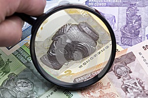 Congolese franc in a magnifying glass photo