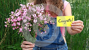 Congrats - beautiful woman with card and flowers