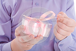 Congratulation! Boy open a gift in a pink box