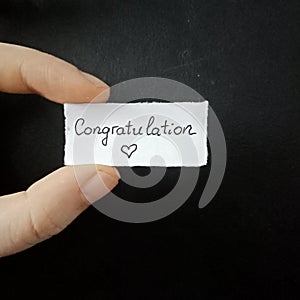 Congratulation note, handwritten tiny mesage, handwriting paper note. photo