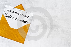 Congratulations award concept -You are a winner card in golden envelope