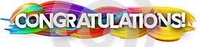 Congratulations paper banner with colorful brush strokes.