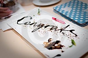 Congratulations Message Written In Chocolate At An Anniversary Party.