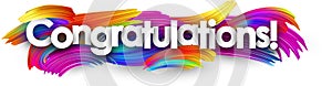 Congratulations paper banner with colorful brush strokes.