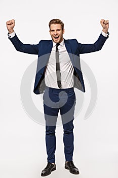 Congratulations we signed important contract. Vertical full-length shot cheerful successful businessman in suit, raising