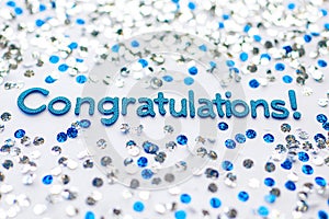 Congratulations text on a white background with silver dots