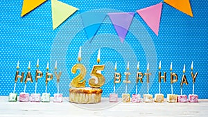 Congratulations on your birthday from the letters of candles number 25 on a blue background with polka dots white copy space.