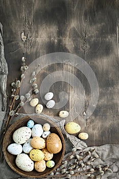 Congratulatory easter background. Easter eggs and flowers. Selective focus. Top view. Background with copy space.