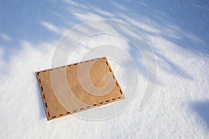 Congratulatory envelope on the snow on a sunny day, template for designer
