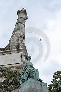 Congress Column, Brussels Belgium with aeroplane flying over head