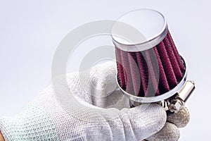 Conical chrome air filter with  - tuning accessory on a gray background