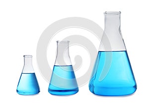 Conical flasks with blue liquid on background. Laboratory glassware