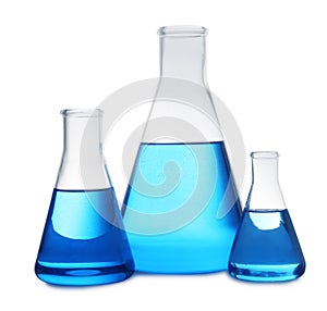 Conical flasks with blue liquid on white. Laboratory glassware
