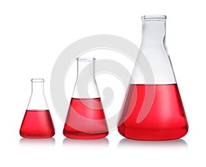 Conical flasks with red liquid on background. Laboratory glassware