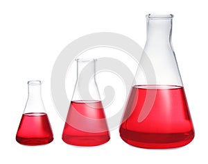 Conical flasks with red liquid on background. Laboratory glassware