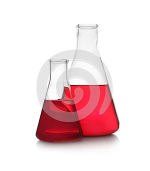 Conical flasks with red liquid on background. Laboratory glassware