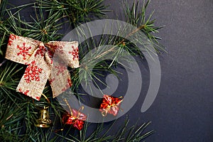 Coniferous branches and Christmas tree decorations on a New Year`s dark background, copy space