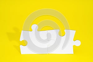 Connect couple puzzle piece on yellow background. Symbol of association and connection, business strategy, completing