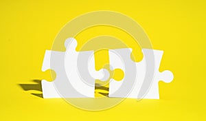 Connect couple puzzle piece on yellow background. Symbol of association and connection, business strategy, completing
