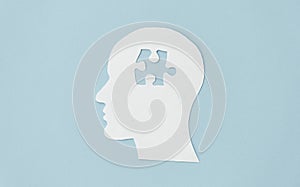 Connect a missing jigsaw puzzle of human brain on blue background. Creative idea for solving problem. Mental health care