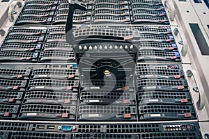 Connect a new hard drive to a stack of computer servers. Replacing a module in a powerful server hardware. Cloud Storage